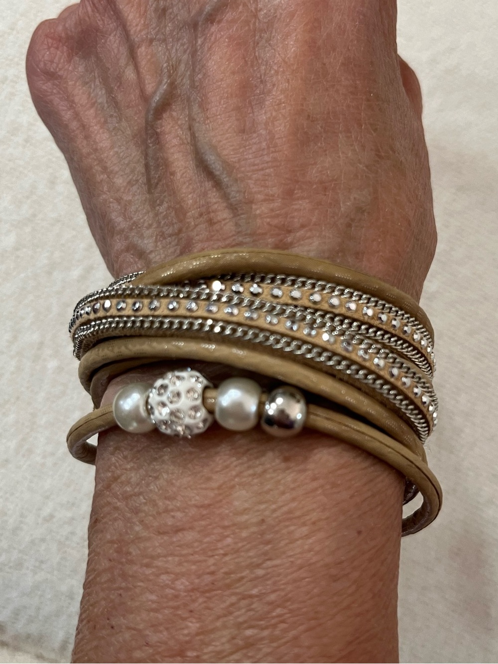 This is a bohemian-style Multi-Strand Beige Pearl and Crystal Wrap Bracelet